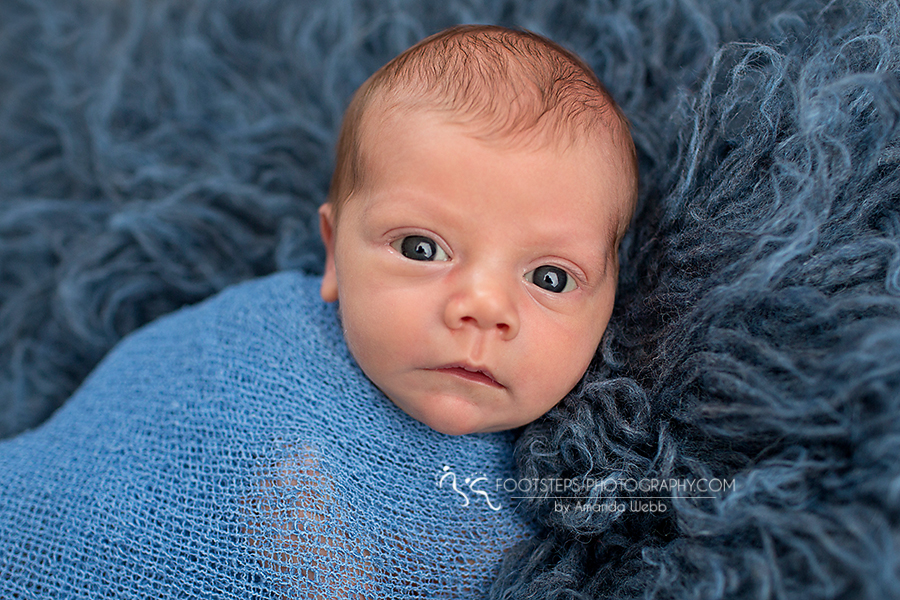 cute newborn baby boy with blue eyes